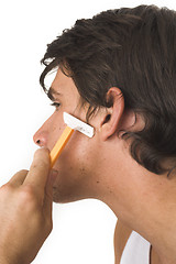 Image showing close up of young man shaving