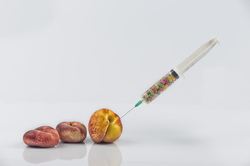 Image showing Peaches and syringe with pills