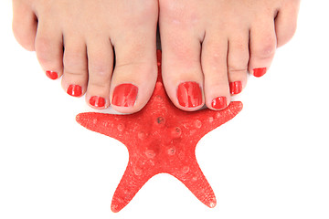 Image showing womens legs (nails) and starfish 