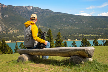 Image showing Man and chihuahua on a bench