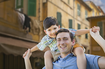 Image showing Father and Son Playing Piggyback on Streets of France