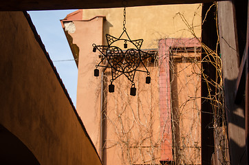 Image showing decorative sun shaped pendant outdoor at cafe 