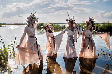 Image showing Pretty women with flower wreath in water