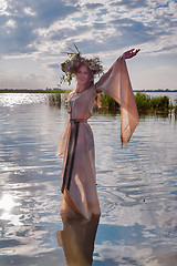 Image showing Beautiful woman with flower wreath in watet