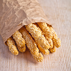 Image showing bread sticks grissini with sesame seeds in craft pack 