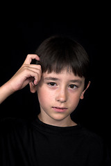 Image showing boy scratching his head