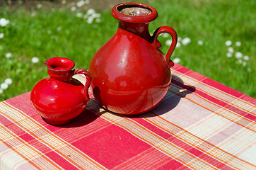 Image showing large and small red retro vintage clay jugs