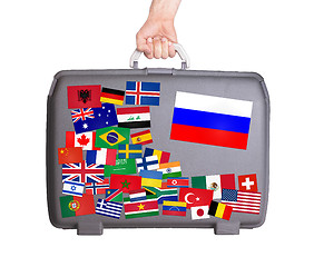 Image showing Used plastic suitcase with stickers