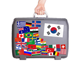 Image showing Used plastic suitcase with stickers