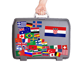 Image showing Used plastic suitcase with stickers