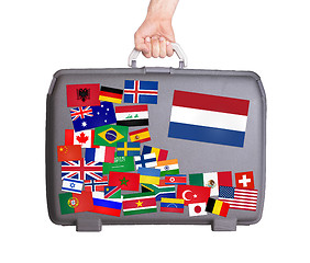 Image showing Used plastic suitcase with stickers