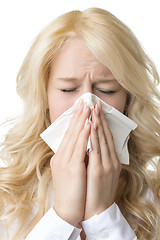 Image showing Ill woman with tissue is sneezing