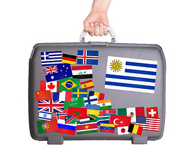 Image showing Used plastic suitcase with stickers