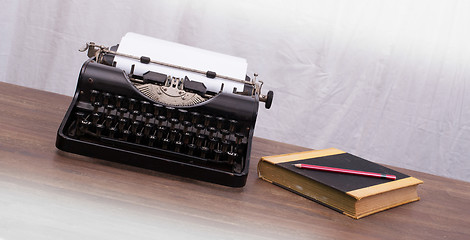 Image showing Vintage typewriter and old books