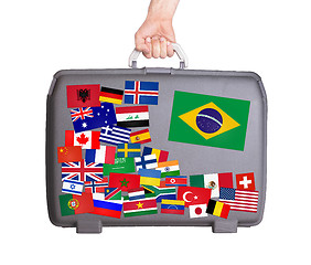Image showing Used plastic suitcase with stickers