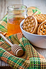 Image showing fresh cookies in a bowl, tablecloth and honey 