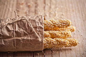 Image showing bread sticks grissini with sesame seeds in craft pack