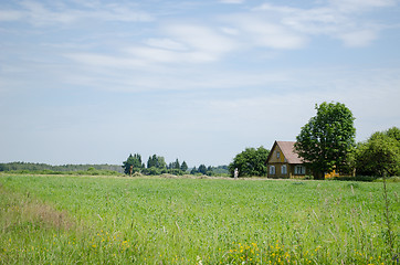 Image showing Couple of farm peasants people rake dry grass 