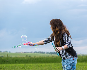 Image showing Beautiful Young Woman make Blowing Bubbles