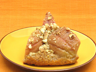 Image showing One slice of a wholemeal apple cake on orange placemat