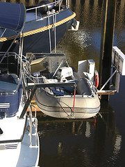 Image showing One boat with dinghy in the harbour