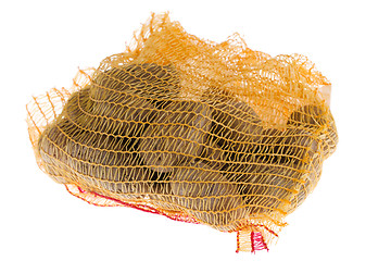 Image showing Ripe potatoes in burlap sack isolated on white background