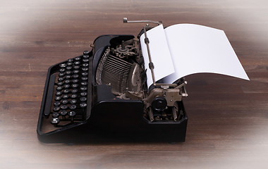 Image showing Vintage typewriter and old books