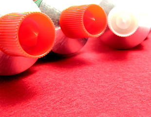 Image showing Three sealed tubes on a red placemat