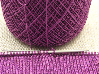 Image showing Pink colored knitting on a  beige background