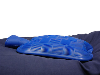 Image showing Blue hot-water bag on a blue pillow