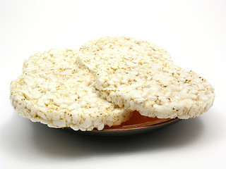 Image showing Slices of puffed rice arranged on a bowl of ceramik on white