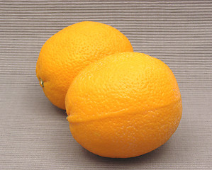 Image showing Two oranges in front of a gray background