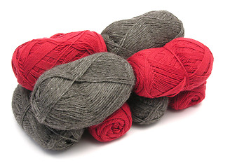 Image showing Gray and red new wool lying upon another on white background