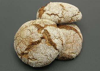 Image showing Home made wholemeal vinschgauer buns on black underlay