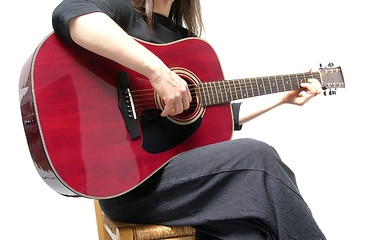 Image showing Cutout woman with guitar sitting on a chair