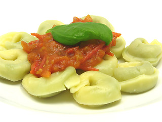 Image showing Stuffed noodles with tomato sauce and a leaf of basil