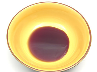 Image showing One bowl of ceramic with  pumpkin seed oil on white