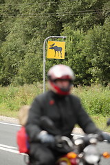 Image showing motorcyclist on a background road sign