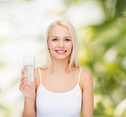 Image showing young smiling woman with glass of water