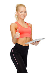 Image showing smiling sporty woman with tablet pc computer