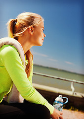 Image showing woman resting after doing sports outdoors