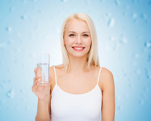 Image showing young smiling woman with glass of water