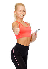 Image showing smiling sporty woman with smartphone