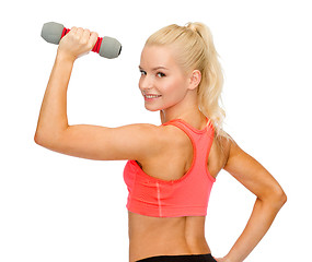 Image showing young sporty woman with light dumbbell