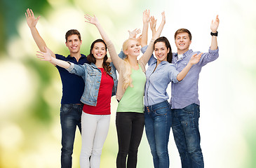 Image showing group of smiling students waving hands