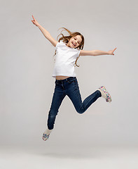 Image showing smiling little girl jumping