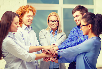 Image showing team with hands on top of each other in office