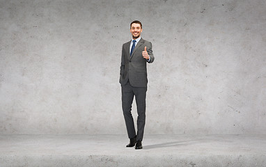 Image showing handsome businessman showing thumbs up