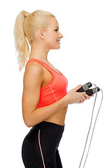 Image showing smiling sporty woman with with skipping rope