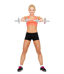 Image showing smiling sporty woman with heavy steel dumbbells